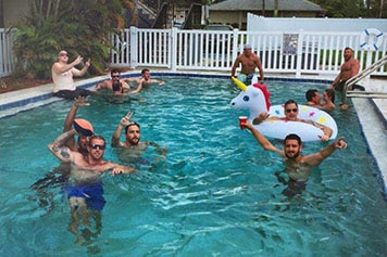 Real Recovery Sober Living residents hanging out in the pool at St Pete sober apartments
