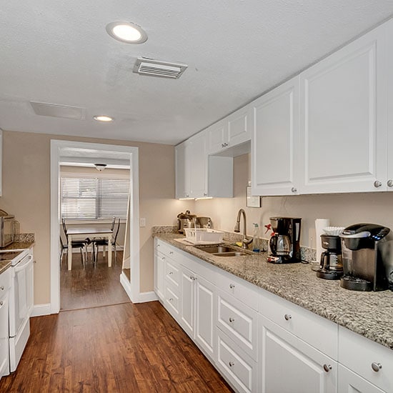 sober living | Tampa property newly renovated kitchen with granite countertops and beautiful hardwood floors