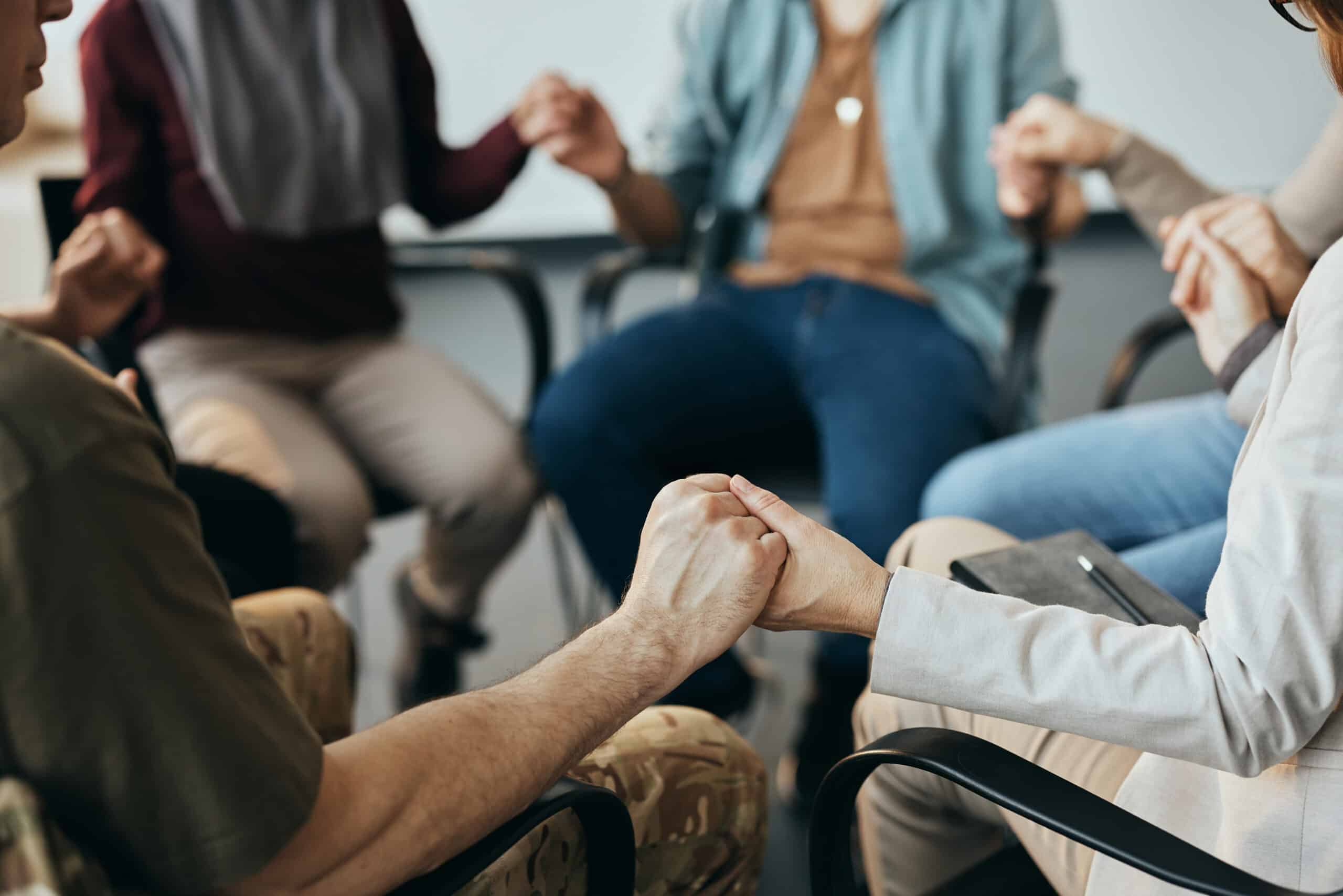alcohol abuse self-assessment | close up of group therapy attenders holding hands 2023 02 02 20 29 08 utc scaled