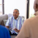 Caucasian senior man sharing his addiction to xylazine and his struggles with withdrawal with multiracial friends in group therapy session. Nursing home, unaltered, listening, sadness, stress, togetherness, support, assisted living, retirement.
