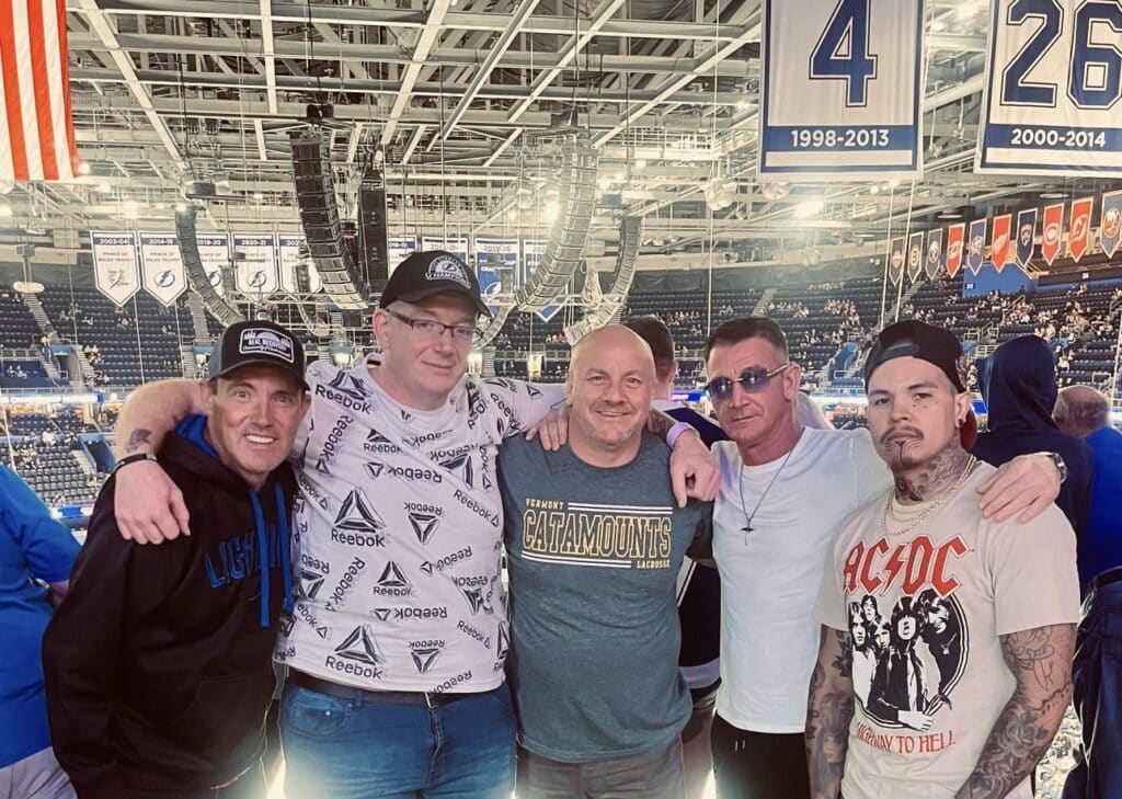 group of sober living men from Real Recovery at a hockey game
